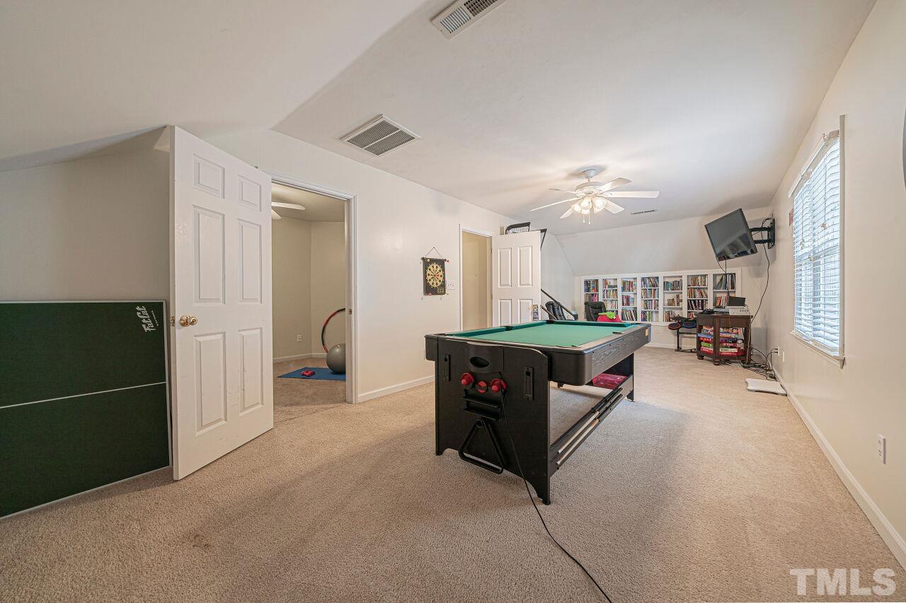 6901 Brigmore Court Raleigh, NC 27617 - Photo 21 of 25 a living room with furniture a dining table and chairs