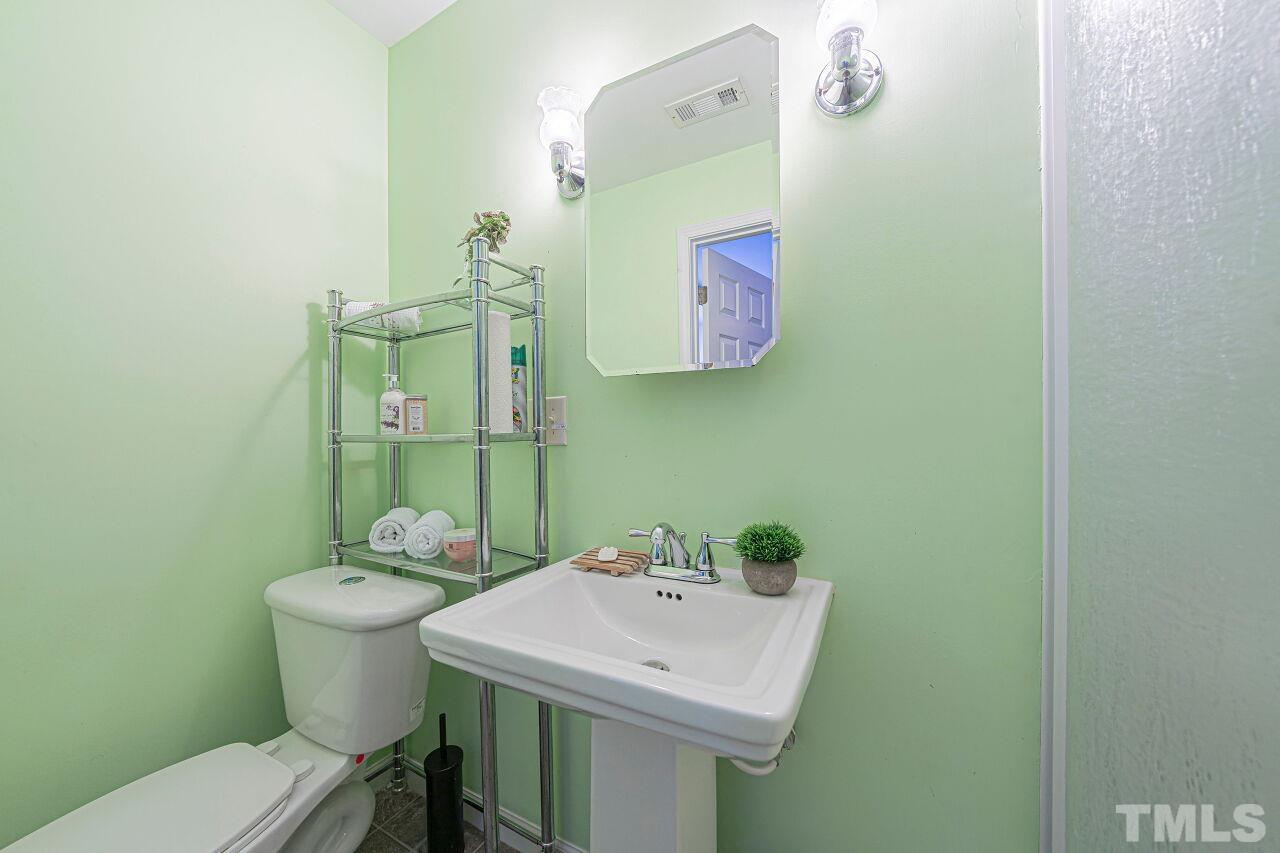 6901 Brigmore Court Raleigh, NC 27617 - Photo 23 of 25 a bathroom with a sink mirror and toilet