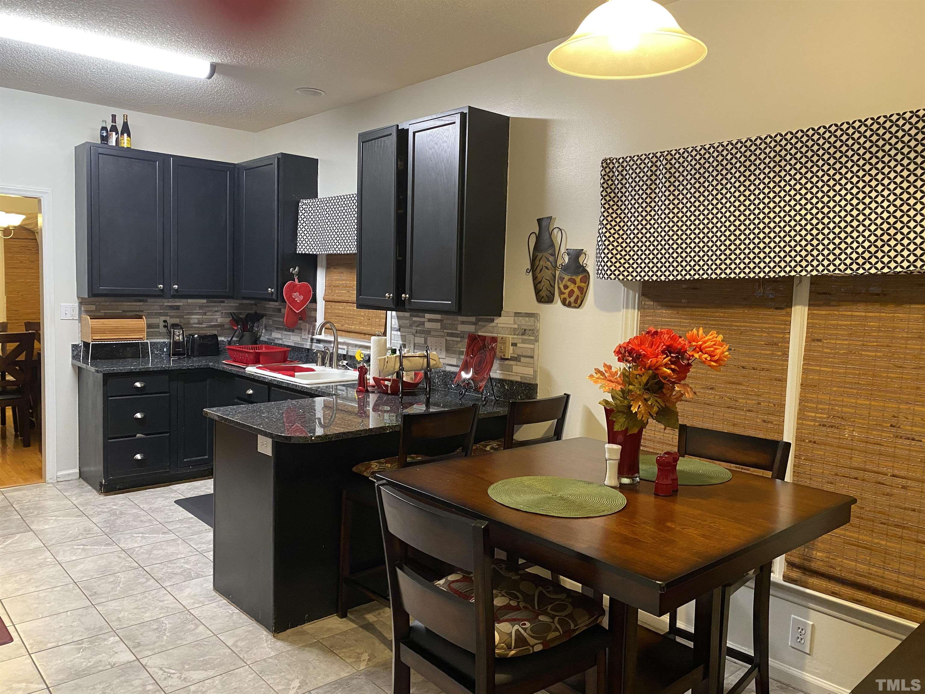 6901 Brigmore Court Raleigh, NC 27617 - Photo 6 of 25 a kitchen with a sink cabinets and appliances