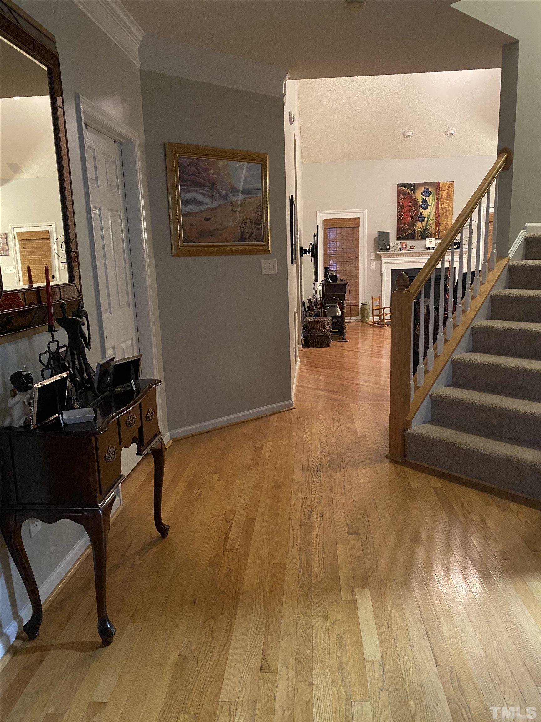 6901 Brigmore Court Raleigh, NC 27617 - Photo 7 of 25 a view of a hallway with workspace and wooden floor