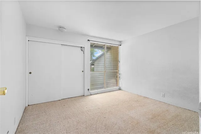 a view of an empty room with brick walls