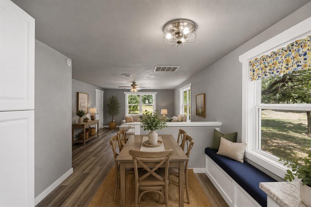 3325 Dove Creek Road Cleburne, TX 76031 - Photo 6 of 40 Dining area featuring wood-finish flooring, a built-in window bench, white trim, and a decorative ceiling light fixture