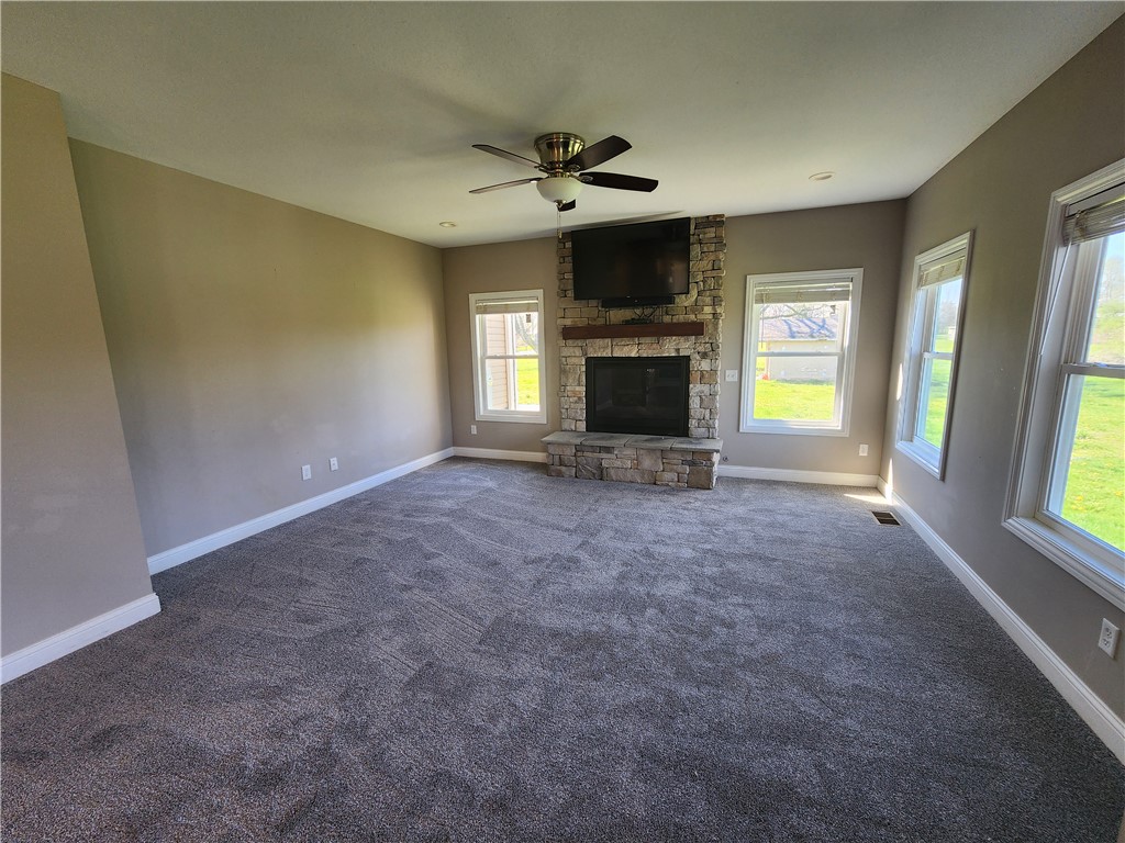 7441 Dodson Road Brookville, OH 45309 - Photo 48 of 50 This expansive great room features a captivating stone fireplace, ideal for relaxation and gatherings.