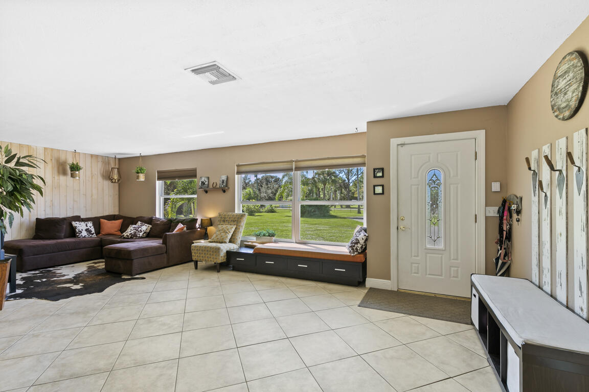 640 27th Street Southwest Naples, FL 34117 - Photo 1 of 37 a living room with furniture and a large window