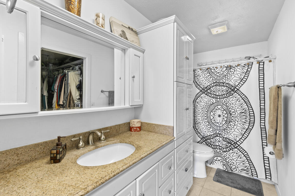 640 27th Street Southwest Naples, FL 34117 - Photo 11 of 37 a bathroom with a granite countertop sink a toilet and shower