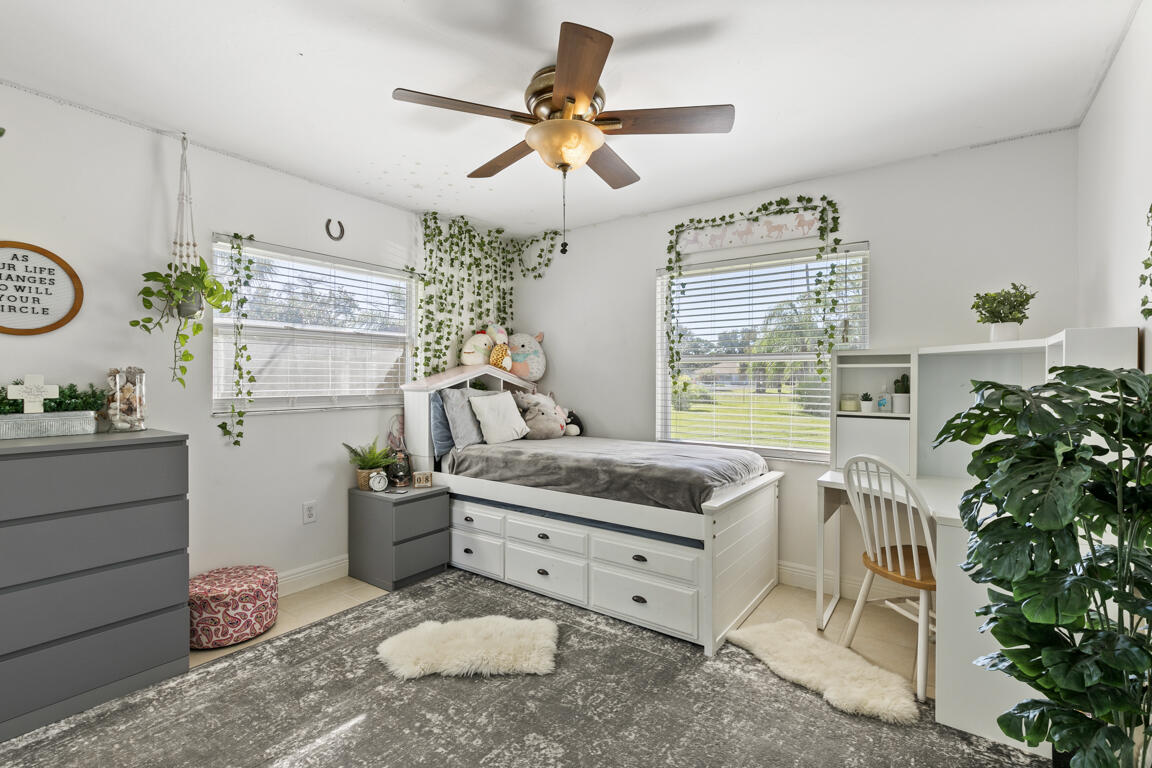 640 27th Street Southwest Naples, FL 34117 - Photo 12 of 37 a living room with furniture and a potted plant