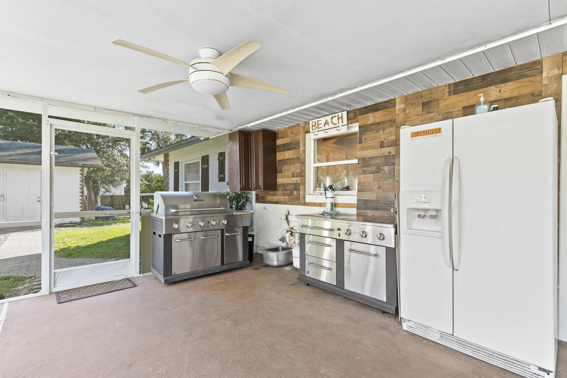 640 27th Street Southwest Naples, FL 34117 - Photo 18 of 37 a kitchen with stainless steel appliances granite countertop a stove a sink and a refrigerator