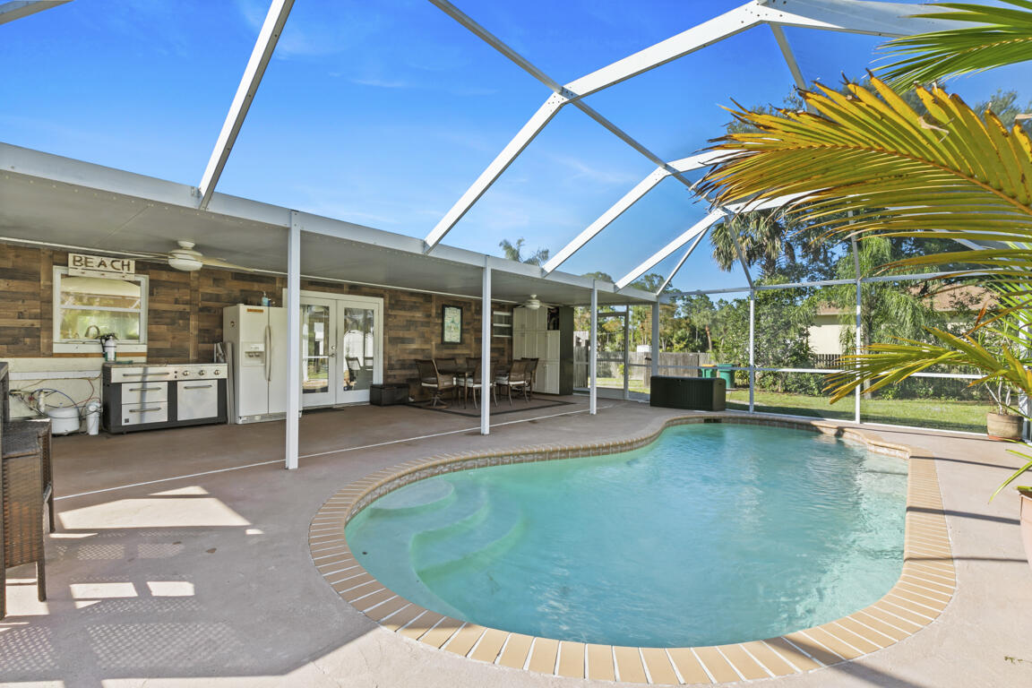 640 27th Street Southwest Naples, FL 34117 - Photo 20 of 37 a view of a swimming pool with a patio