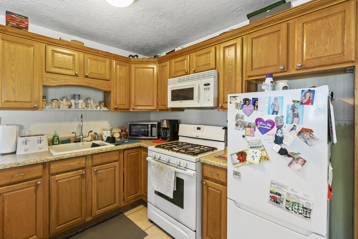 640 27th Street Southwest Naples, FL 34117 - Photo 26 of 37 a kitchen with stainless steel appliances a stove a microwave and cabinets