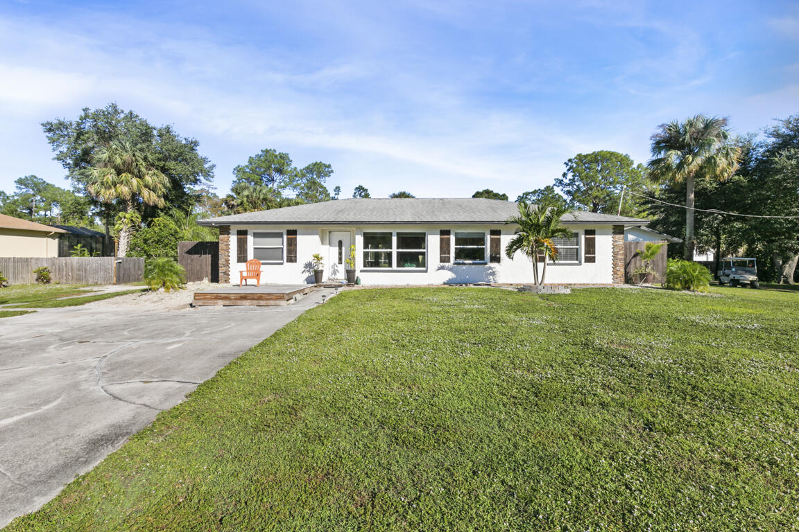640 27th Street Southwest Naples, FL 34117 - Photo 29 of 37 a front view of a house with a yard table and chairs