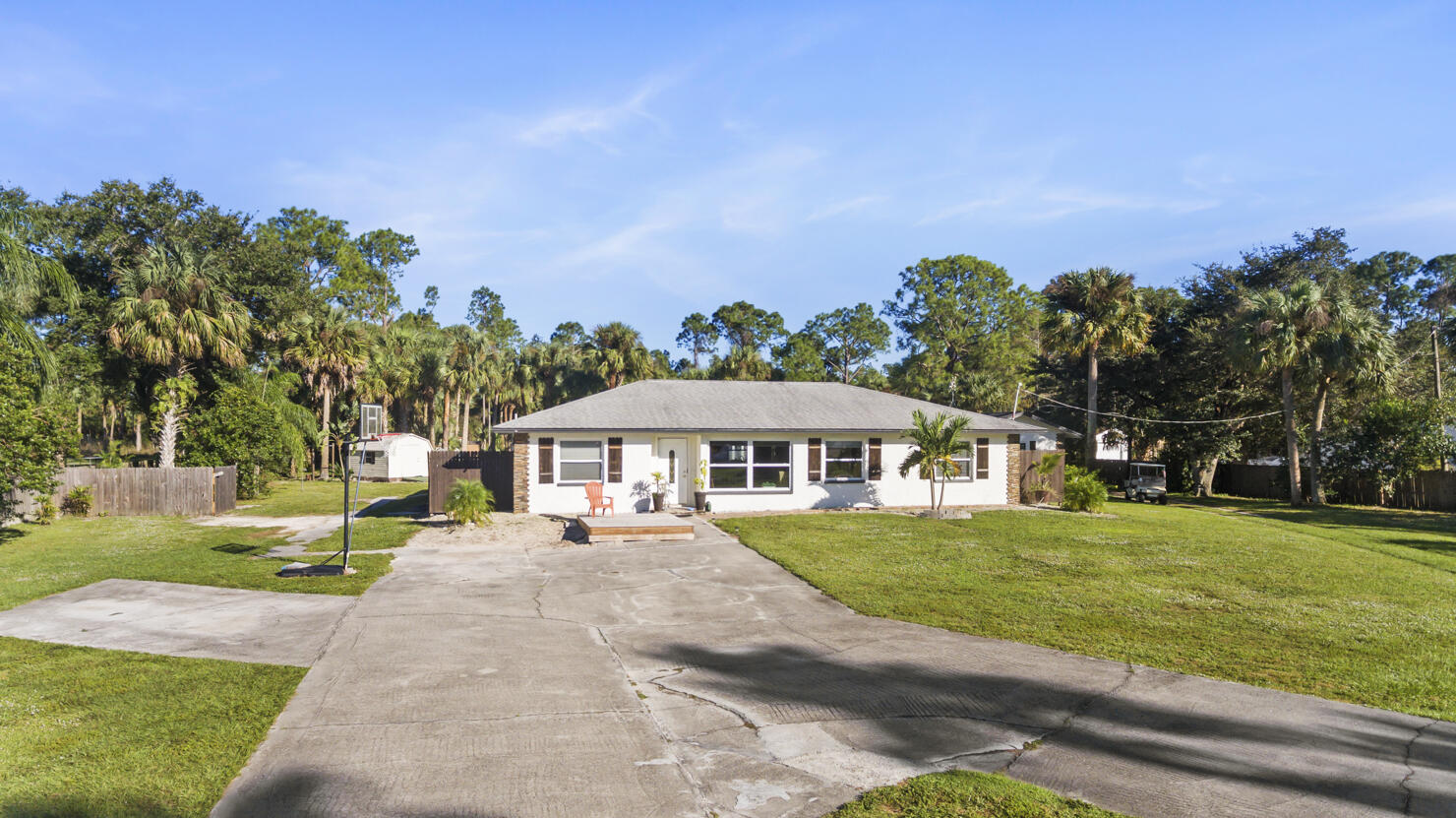 640 27th Street Southwest Naples, FL 34117 - Photo 30 of 37 a front view of a house with a yard and trees
