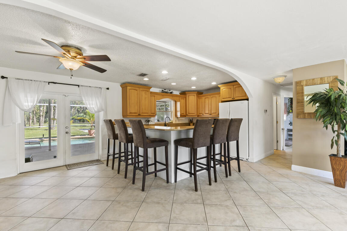 640 27th Street Southwest Naples, FL 34117 - Photo 5 of 37 a view of a dining room with furniture and chandelier