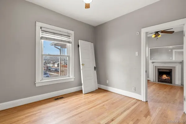an empty room with windows and a fireplace