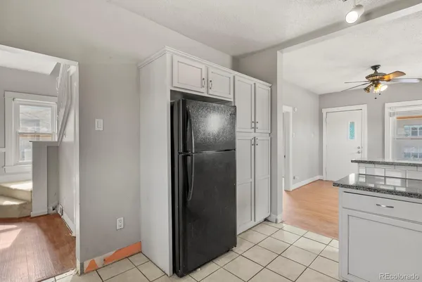 a kitchen with a refrigerator and a sink