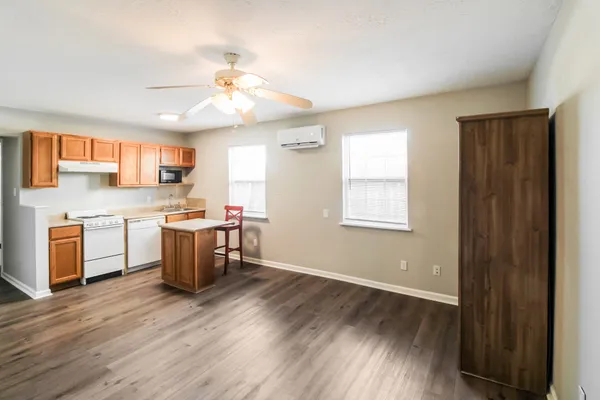 a kitchen with a sink window and cabinets