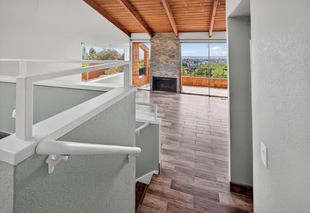 a view of a room with wooden floor and cabinet