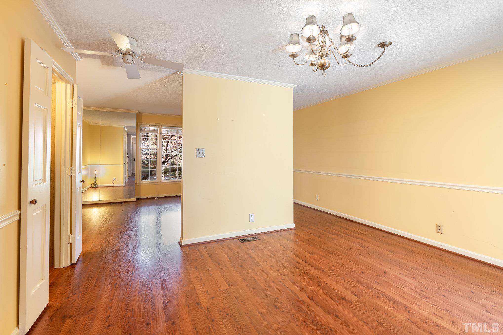 3051 Wycliff Road Raleigh, NC 27607 - Photo 3 of 18 a view of a hallway with wooden floor