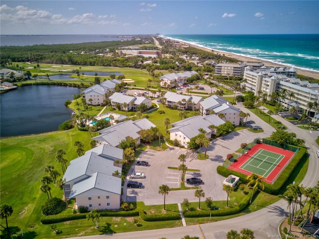484 Northeast Plantation Road, Unit 4106 Jensen Beach, FL 34957 - Photo 1 of 15 an aerial view of ocean and residential houses with outdoor space