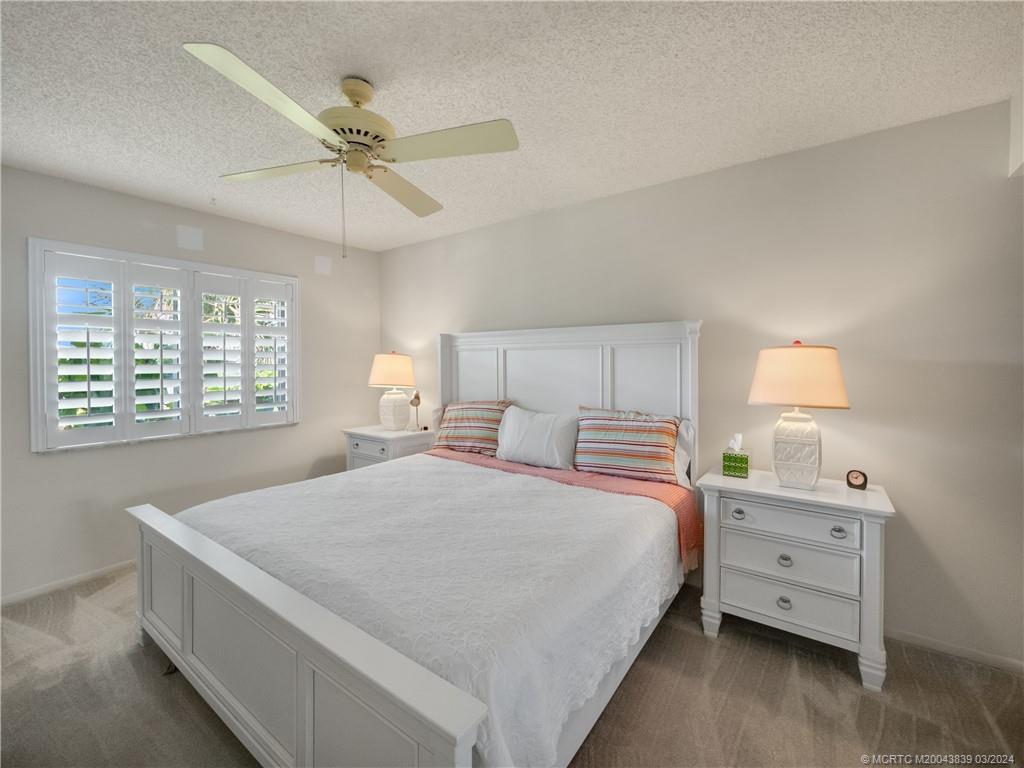 484 Northeast Plantation Road, Unit 4106 Jensen Beach, FL 34957 - Photo 11 of 15 a bedroom with a bed and a window