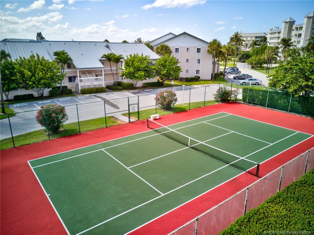 484 Northeast Plantation Road, Unit 4106 Jensen Beach, FL 34957 - Photo 14 of 15 a tennis court that has tennis net