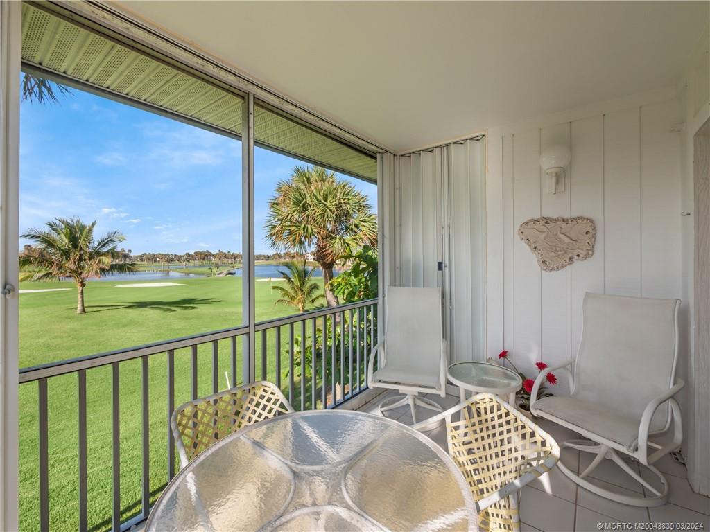 484 Northeast Plantation Road, Unit 4106 Jensen Beach, FL 34957 - Photo 2 of 15 a balcony with furniture and a potted plant