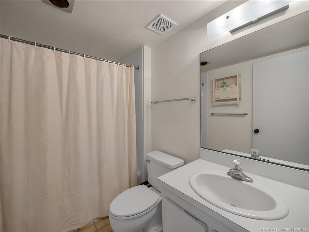 484 Northeast Plantation Road, Unit 4106 Jensen Beach, FL 34957 - Photo 10 of 15 a bathroom with a sink toilet and shower