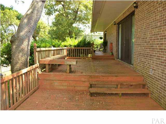 8801 Burning Tree Road Pensacola, FL 32514 - Photo 18 of 24 The open wood deck runs the entire length of the back of the house.