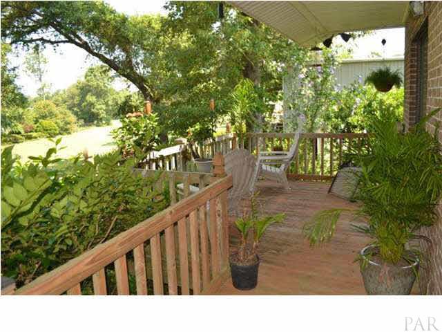 8801 Burning Tree Road Pensacola, FL 32514 - Photo 20 of 24 The deck has access from the great room and master bedroom and overlooks #4 tee box.