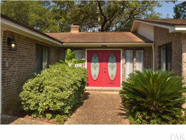 The Inviting entry has double doors with etched oval glass panels flanked by side light windows.