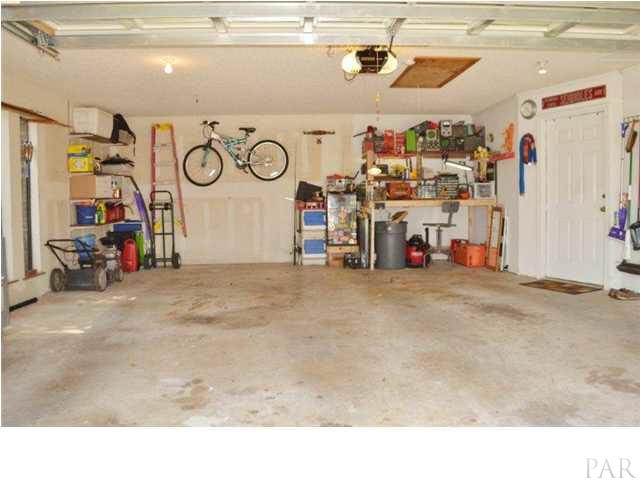 8801 Burning Tree Road Pensacola, FL 32514 - Photo 24 of 24 Super clean two-car garage is side-entry with an exposed aggregate driveway and off-street guest parking.