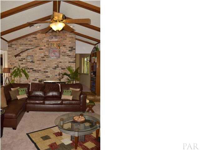 by its cathedral ceiling, open wood beams, and Old Chicago brick fireplace.