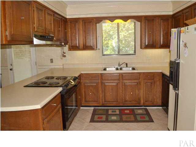 8801 Burning Tree Road Pensacola, FL 32514 - Photo 8 of 24 Spacious kitchen recently updated with ceramic tile floors; and lots of cabinets,