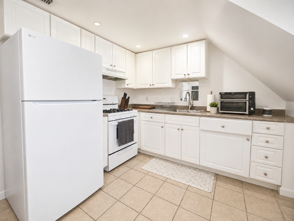 5 Myrtle Street, Unit 3 Saugus, MA 01906 - Photo 8 of 15 a kitchen with cabinets stainless steel appliances and sink