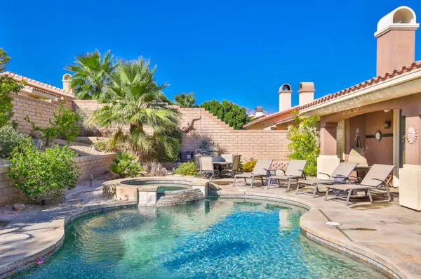 a view of swimming pool with outdoor seating and plants
