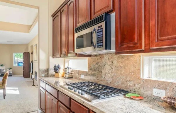 a kitchen with a sink stove and cabinets