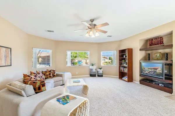 a view of a dining room with furniture and a chandelier