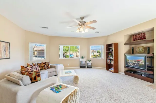 a view of a dining room with furniture and a chandelier
