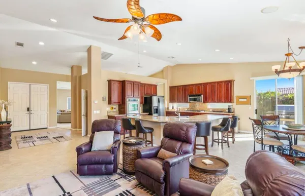 a living room with furniture and large windows