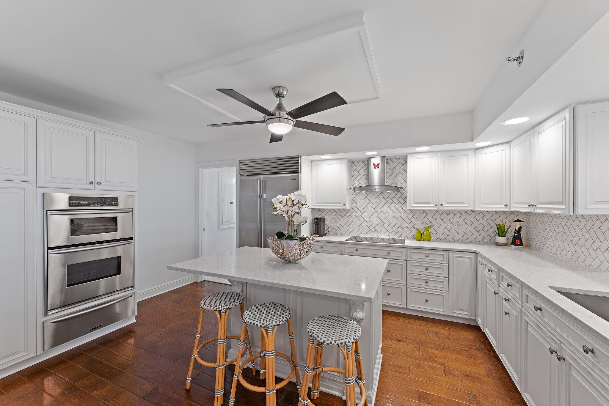 19670 South Beach Road, Unit B303 Jupiter, FL 33469 - Photo 5 of 104 a kitchen with granite countertop a sink appliances cabinets and furniture
