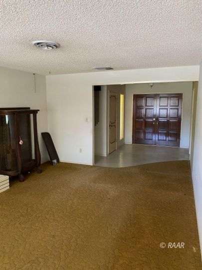 535 West Kevin Court Ridgecrest, CA 93555 - Photo 7 of 19 a view of an empty room with a fireplace