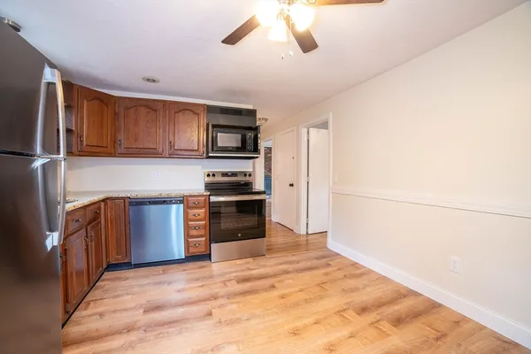 a kitchen with stainless steel appliances a refrigerator and a stove top oven