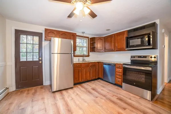 a kitchen with stainless steel appliances granite countertop a refrigerator and a stove top oven