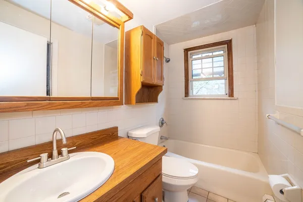 a bathroom with a sink a toilet and a bathtub