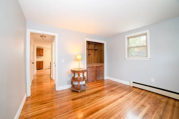 a view of a room with wooden floor lounge chair and windows