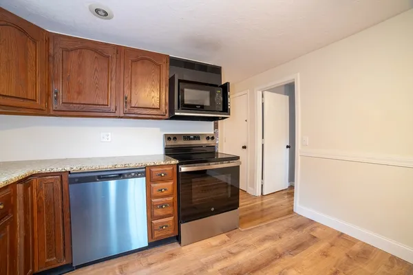 a kitchen with stainless steel appliances granite countertop a stove a sink and a refrigerator