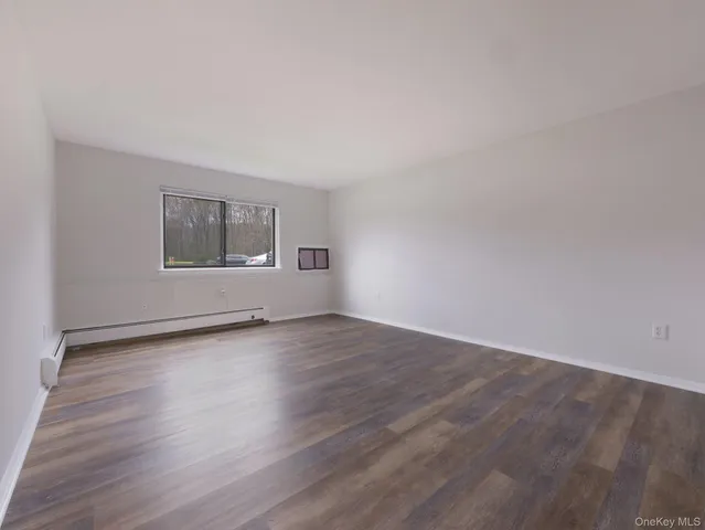 a view of an empty room and wooden floor