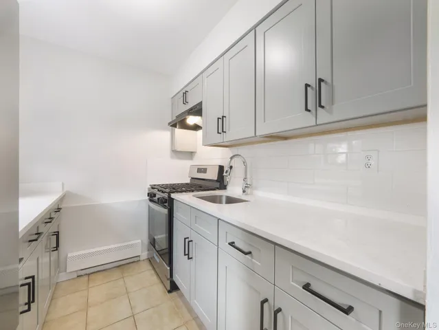 a kitchen with a sink dishwasher and cabinets