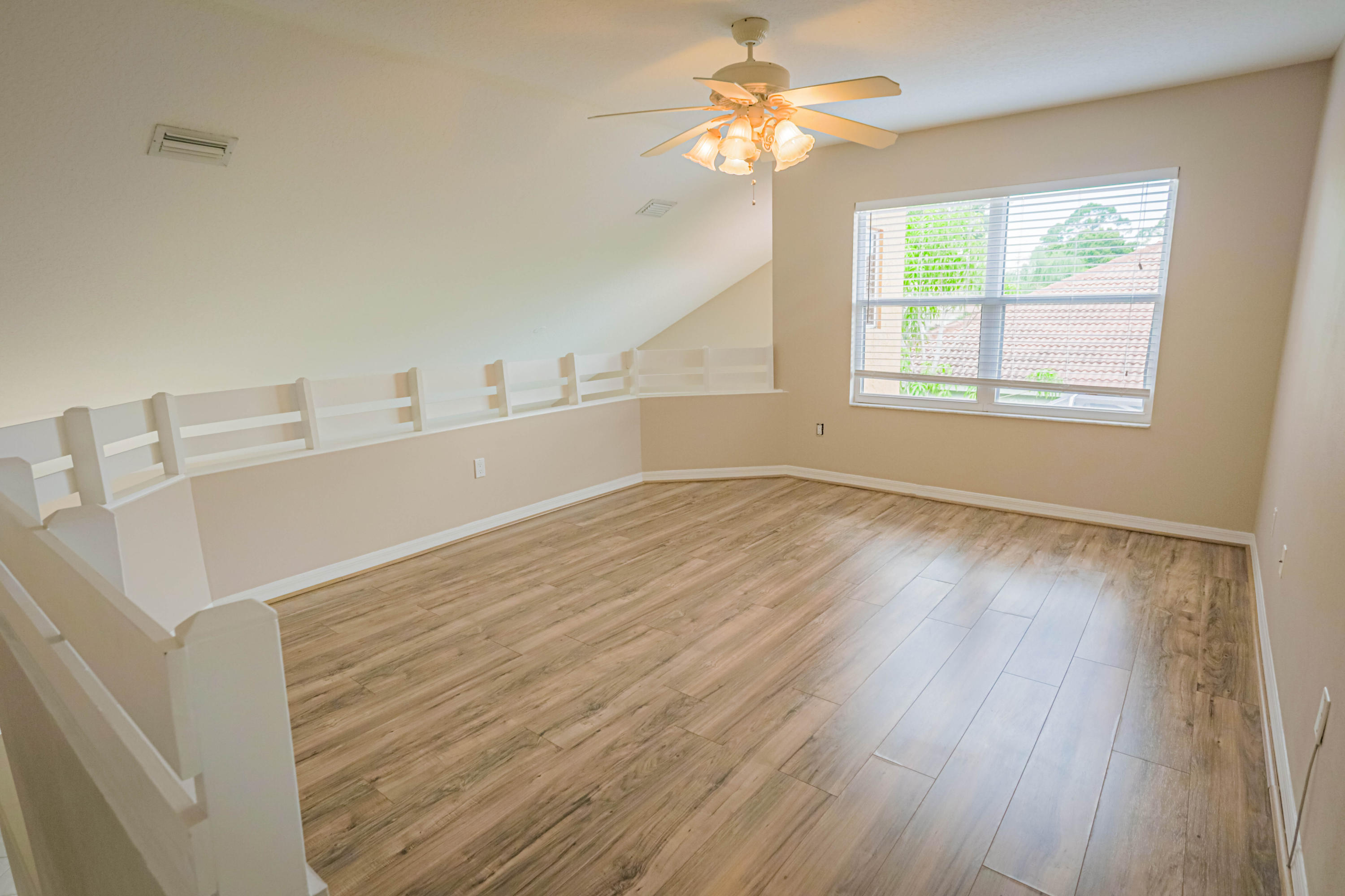 5218 Edenwood Road Riviera Beach, FL 33418 - Photo 13 of 31 a view of a livingroom with wooden floor and a ceiling fan