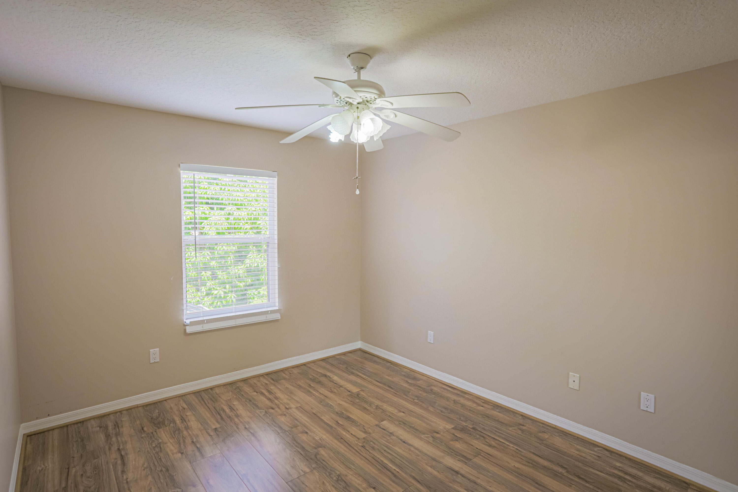 5218 Edenwood Road Riviera Beach, FL 33418 - Photo 15 of 31 an empty room with a window and a fan