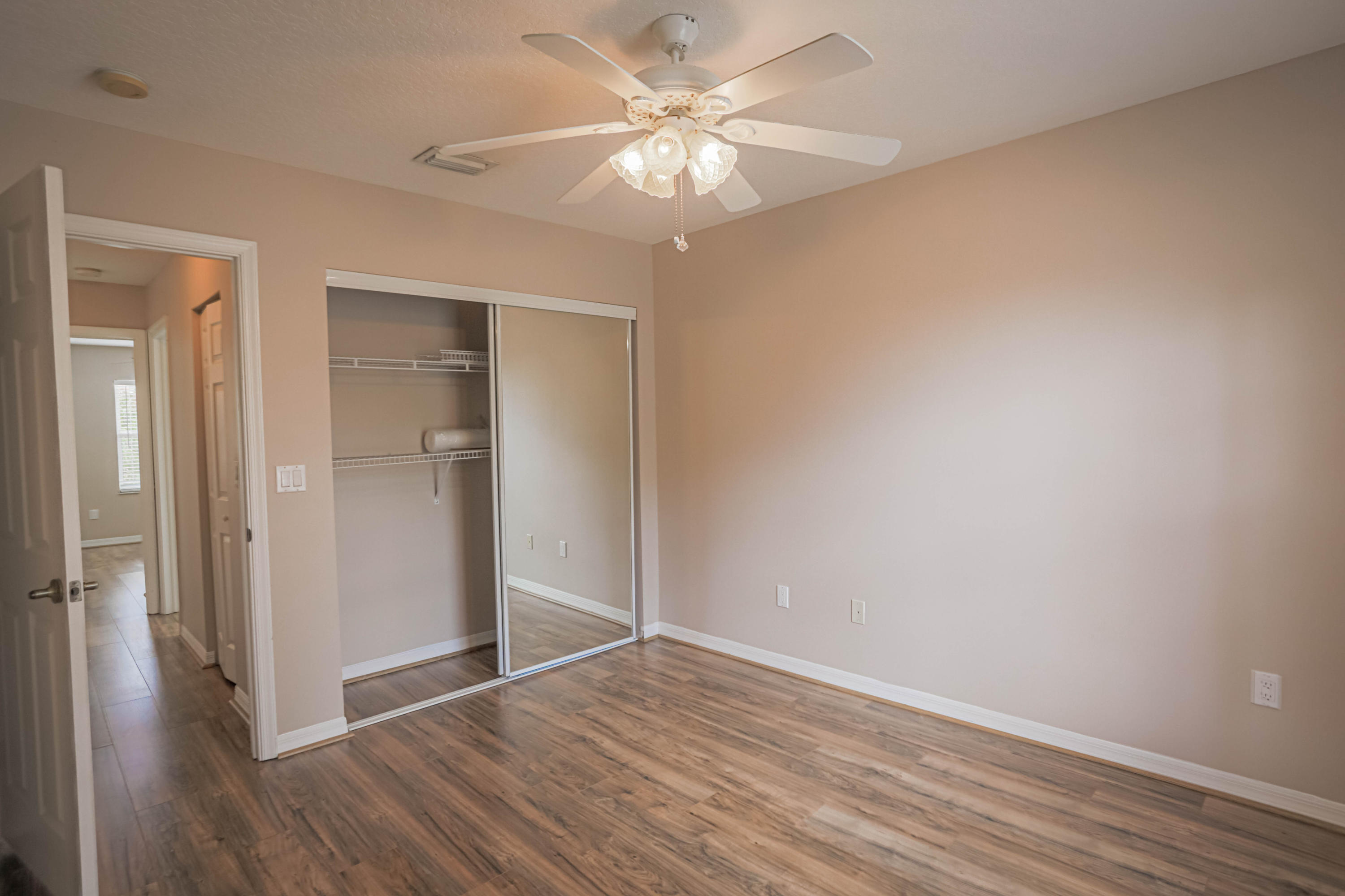 5218 Edenwood Road Riviera Beach, FL 33418 - Photo 18 of 31 a view of an empty room with wooden floor